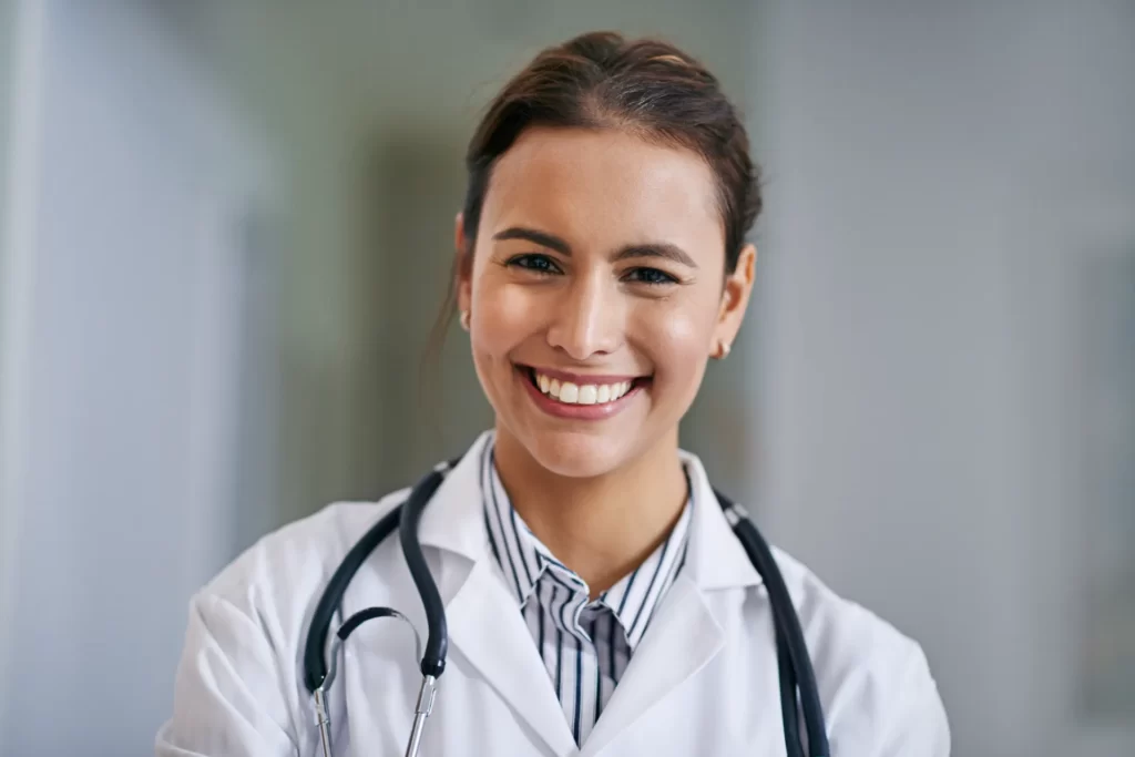 smiling woman in lab coat with stethoscope utc